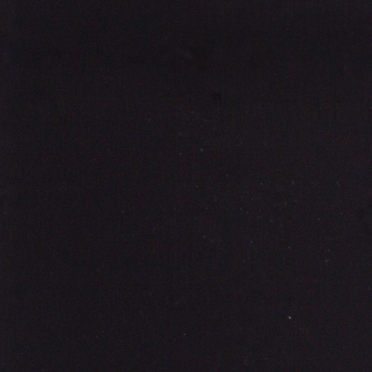 dark black natural stone surface with subtle speckled texture and smooth finish for wall use