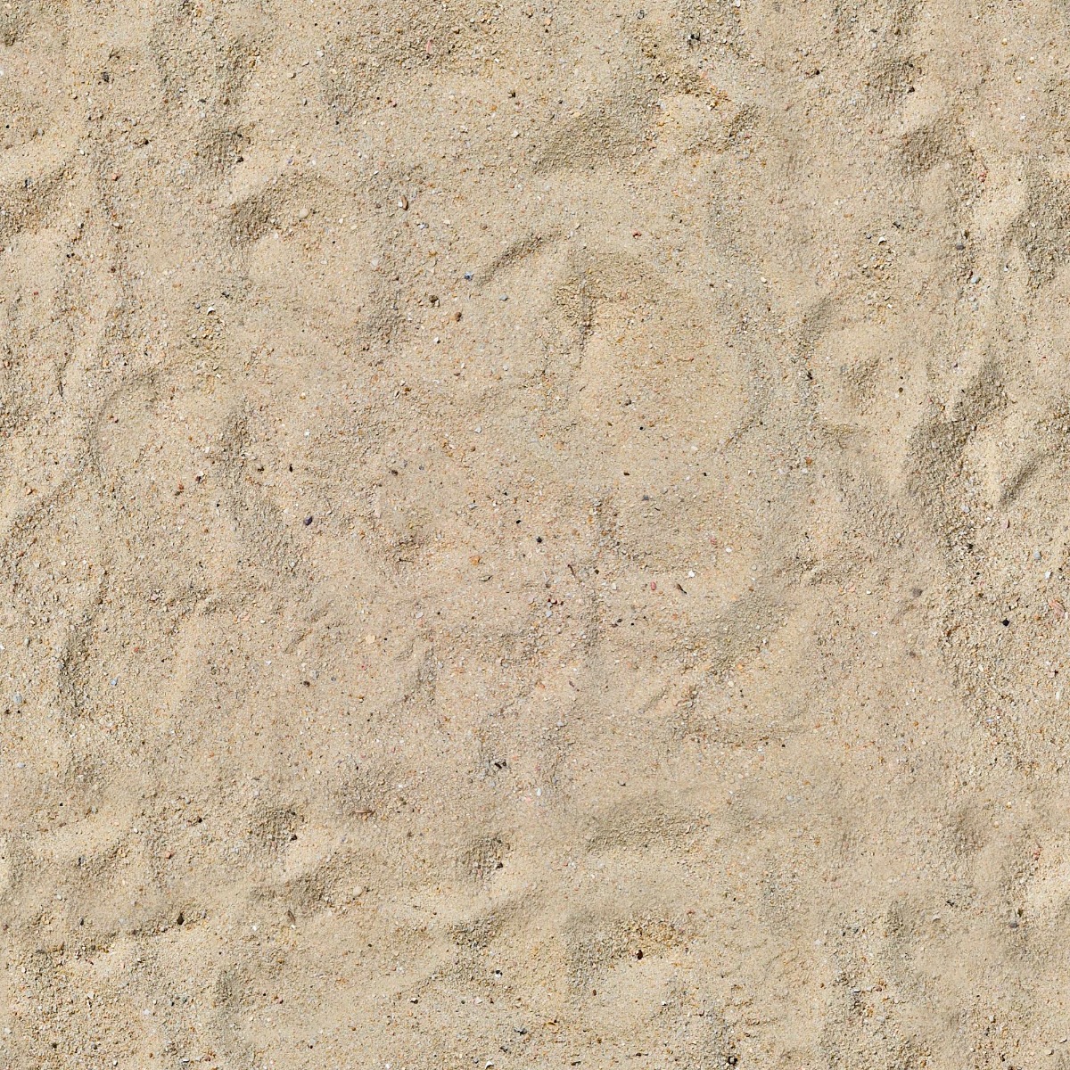 close-up of light beige natural sand with fine grains and scattered small pebbles
