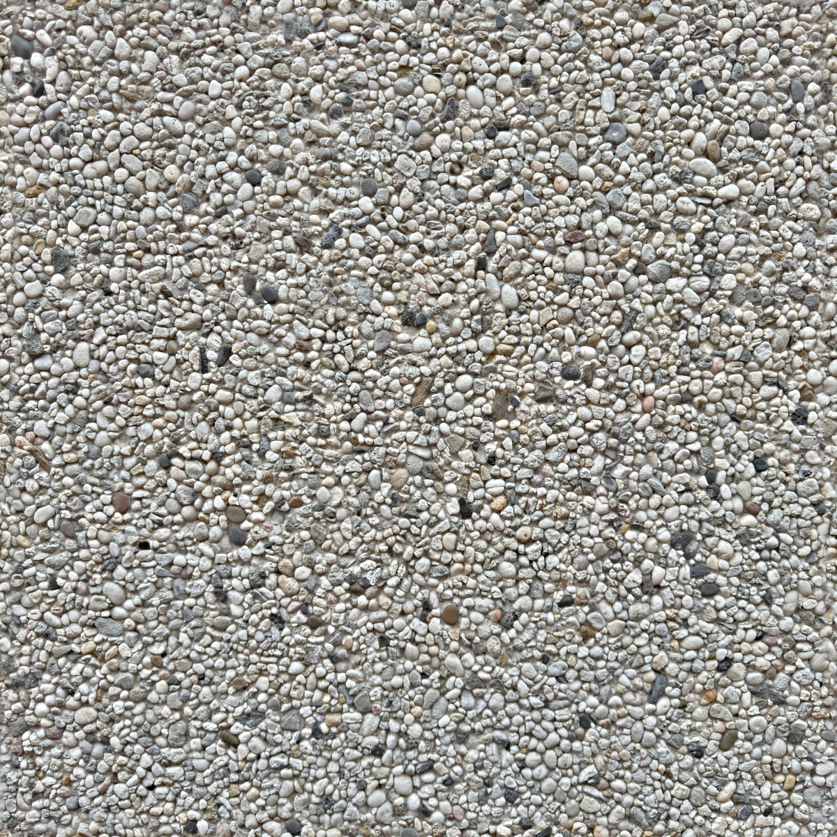 rough pebbledash wall surface with small grey and beige stones embedded in cement render