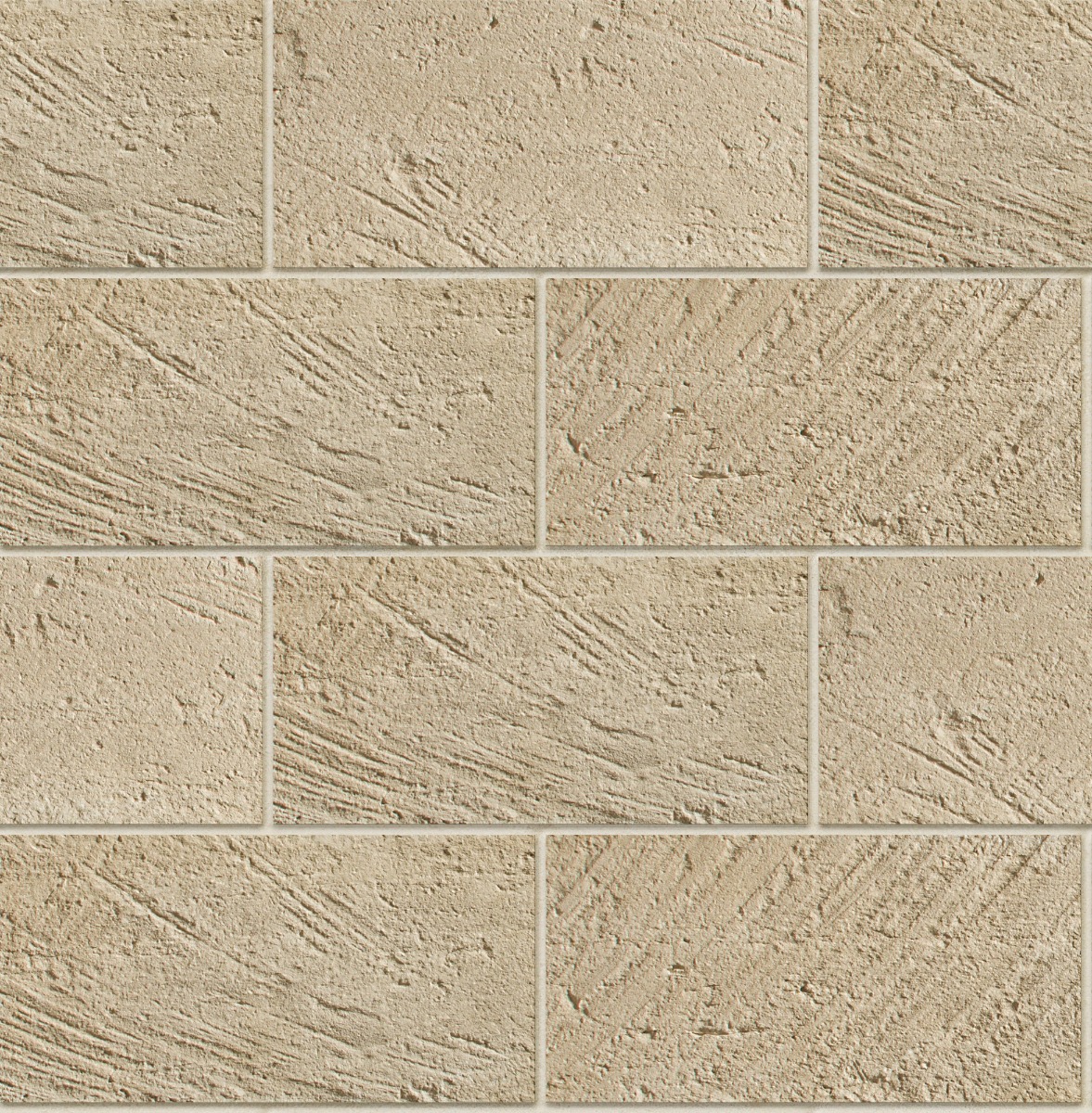 Beige carved rectangular stone tiles arranged in a staggered brick pattern with rough textured surface and grout lines