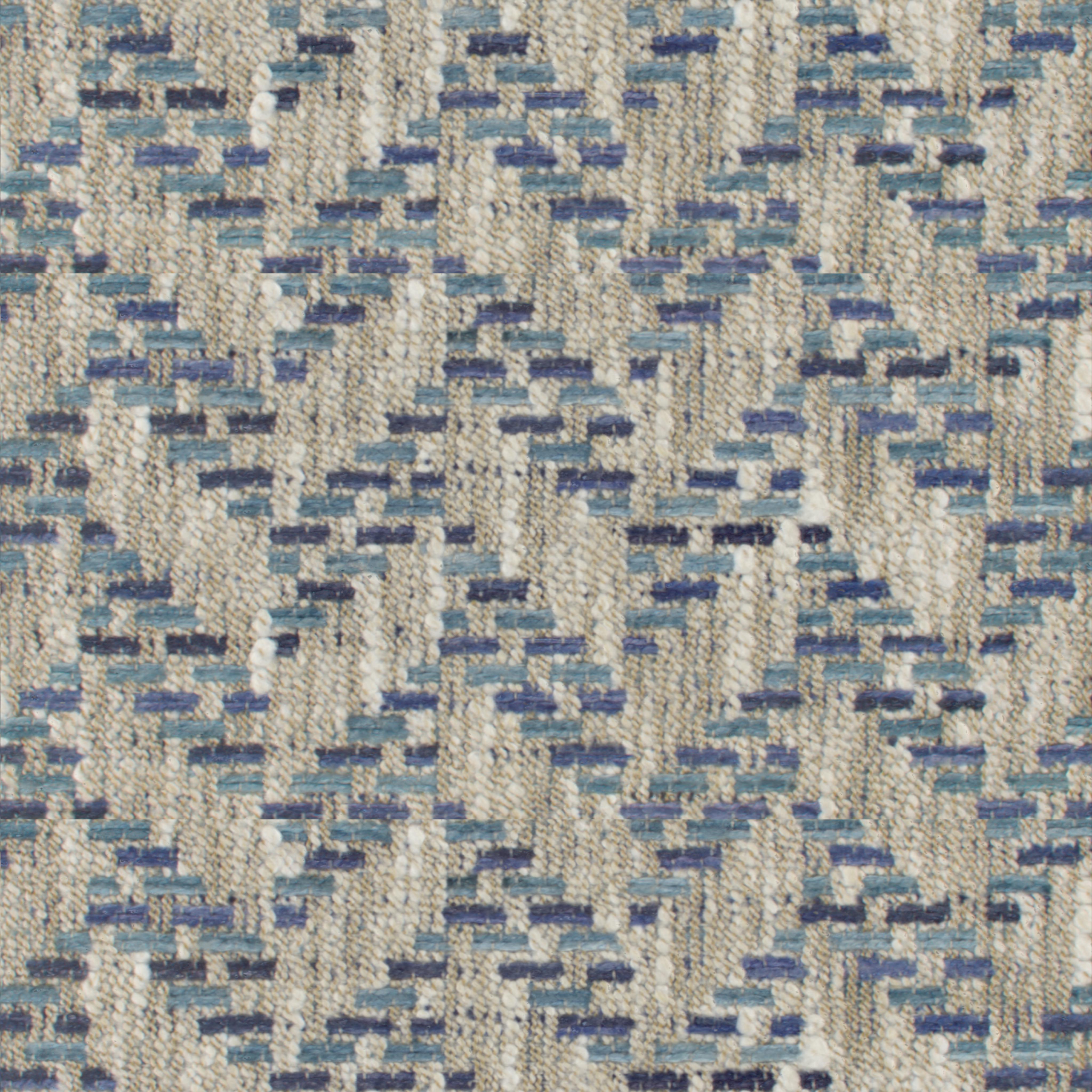 Close-up of blue and beige woven upholstery fabric with a subtle geometric pattern and textured surface