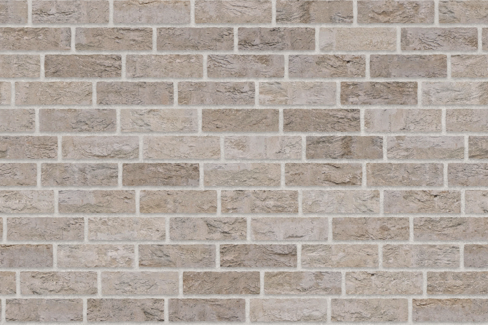 buff-coloured clay brick wall with staggered running bond pattern and rough texture