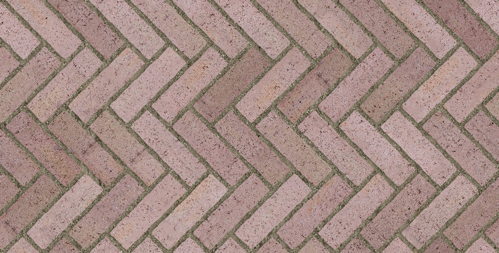pink clay brick paving laid in a herringbone pattern with moss in the joints