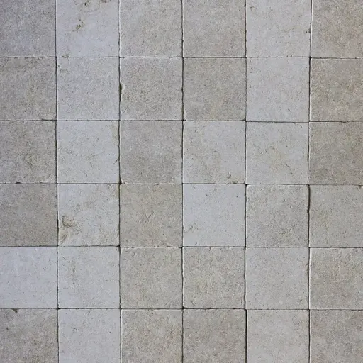Natural limestone paving tiles in light grey with textured surface, suitable for outdoor flooring and paving.